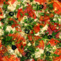 Pizza with tomatoes and greens